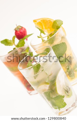 Three variation of Mojito cocktails, a Cuban cocktail made with cuban rum, lime, sugar, a splash of soda and flavoured with fresh fruit of your choice