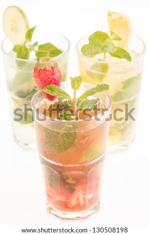 Colorful Mojito cocktails,  a Cuban cocktail made with cuban rum, lime, sugar, a splash of soda and flavoured with fresh fruit of your choice