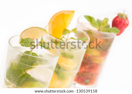 Three colorful variation of Mojito in a row, a Cuban cocktail made with cuban rum, lime, sugar, a splash of soda and flavoured with fresh fruit of your choice