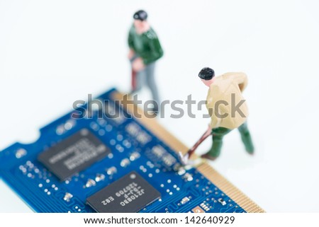 Miniature workmen working on the computer RAM, Random Access Memory, part top view close up