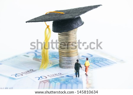 Education cost concept with the miniature man and woman looking at the Mortarboard on top of a stack of Euro coins and 20 Euro banknotes