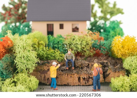 Miniature construction workers getting ready to renovate the house