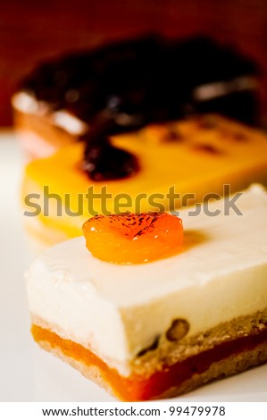 Three assorted cakes slices on a white plate