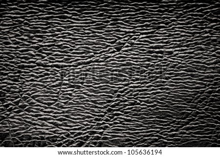 black leather background with white light reflexes