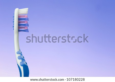 blue and white toothbrush on blue background