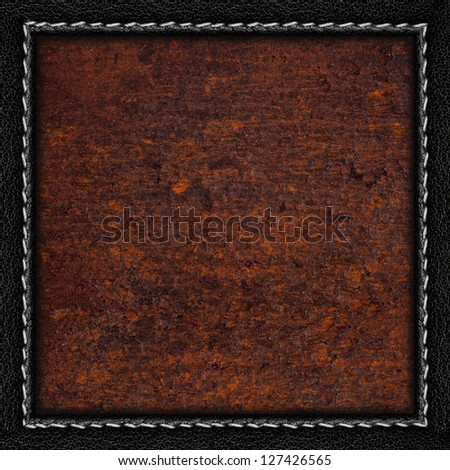rust metal sheet background or iron brown texture in black leather frame