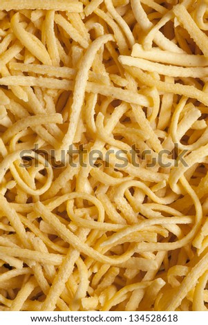 yellow dried pasta background or food texture