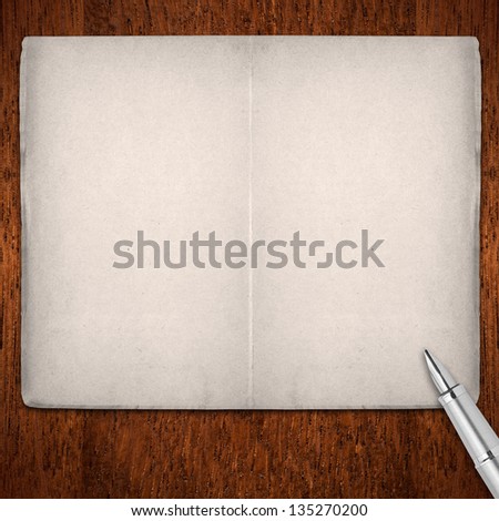 open blank pages book with silver fountain pen on brown wooden background