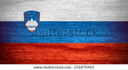 Slovenia flag or Slovenian banner on wooden texture