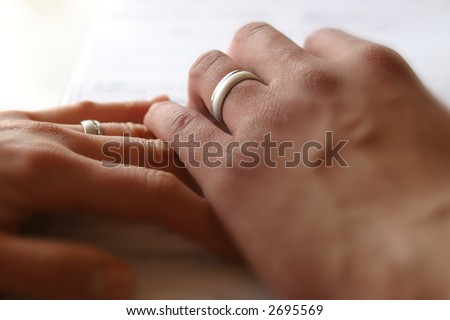 Two hands. Men\'s hand over woman\'s. Close-Up. Shallow DOF.