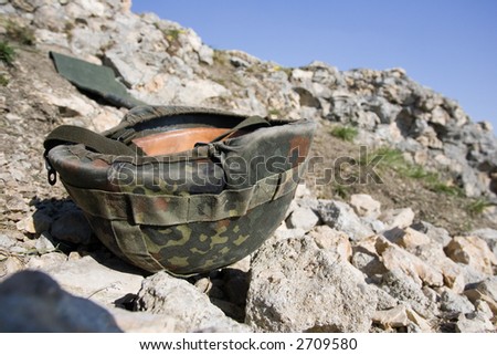 Lost military hard hat lying in the mountains. It is a german helmet.