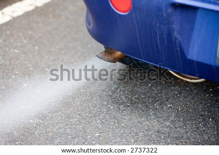 Exhaust pipe of a blue car - blowing out the pollution.