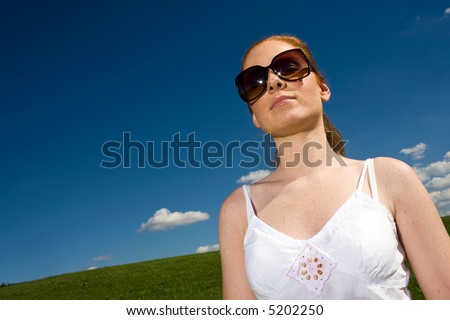 Woman with big sunglasses. Outside with airy clothes. It is great summer. Azure sky, Meadow goes to horizon.
