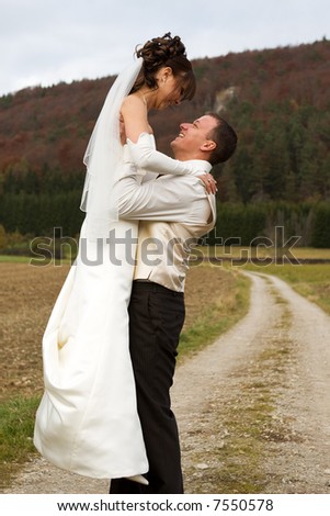 Groom lifts his bride up