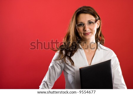Female secretary with black folder before her chest. She is appealing!