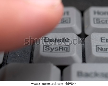Close up of finger pressing delete on keyboard