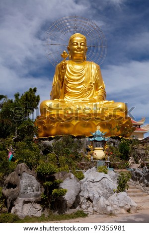 Golden Buddha holding the golden lotus.