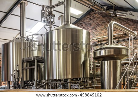 Modern beer plant (brewery), with brewing kettles, vessels, tubs and pipes made of stainless steel.