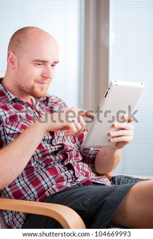 Focused man working and playing with tablet computer (lots of co