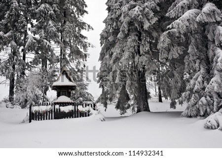 Christian chapel in the snowy woods in Tatra Mountains