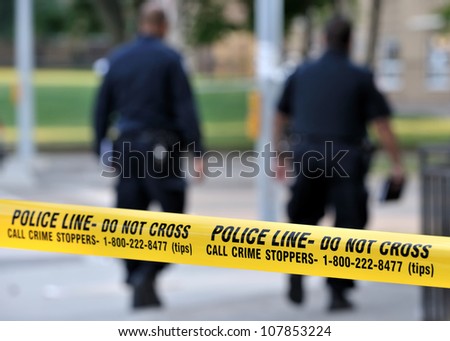 Toronto-July 17: Police Line Do Not Cross Tape With Two Officers In The Background At The Crime Scene Where Shooting Leaves 2 Dead And 21 Injured On July 17, 2012 In Toronto