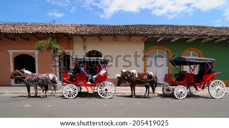GRANADA - MARCH 19: Unidentified people at horse carts on March 19, 2014 in Granada, Nicaragua. Horse cart ride is a main tourist\'s attraction in Granada.