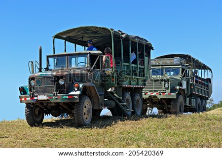 GRANADA - MARCH 19: Two military safari trucks with unidentified tourists on March 19, 2014 in Granada, Nicaragua. The military trucks are the only reliable transport in Nicaraguan rural areas.