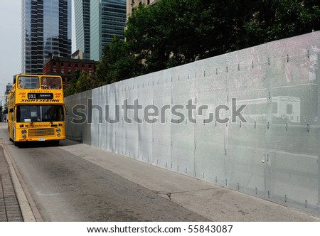 TORONTO-JUNE 23: A tour bus passes near a 3 meter high steel wire fence on June 23, 2010 in Toronto. The fence is in preparation for the upcoming G20 Summit.