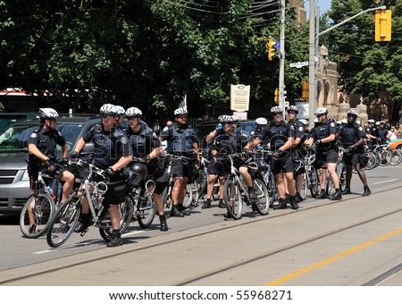 TORONTO-JUNE 25:Large group of Police on bicycles observe protesters at G20 Protest on June 25, 2010 in Toronto, Canada.