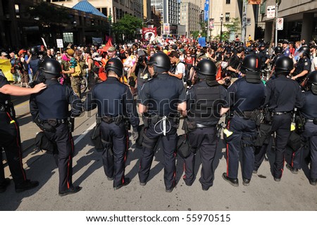 TORONTO-JUNE 25: Toronto Riot Police standing in front of protesters on June 25, 2010 in Toronto, Canada.