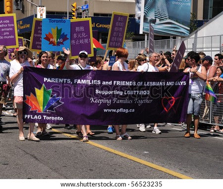 TORONTO - JULY 04: Parents, Families and Friends of Lesbians and Gays activists walking with banner at Pride parade in Toronto, July 04, 2010