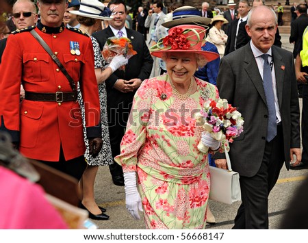TORONTO-JULY 06: The Queen, dressed in a bright pink hat with a light green ribbon and a matching patterned dress, smiled and chatted with many in the crowd in Toronto, July 06, 2010