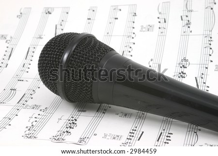 black microphone on sheet music