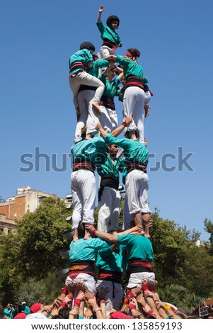BARCELONA, SPAIN - APRIL 21: Team Castellers of Sagrada Familia performing a human pyramid in the festival of La Sagrada Familia on April 21, 2013 in Barcelona, Spain.