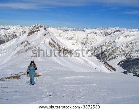Woman mountain trekker with snow shoes -  Les Orres - Alps - France.