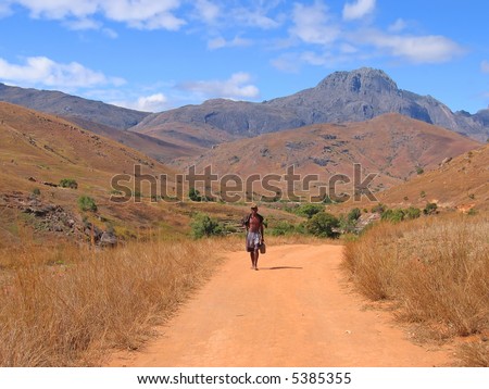 stock photo Man walking alone with nude feet on a dirty track 