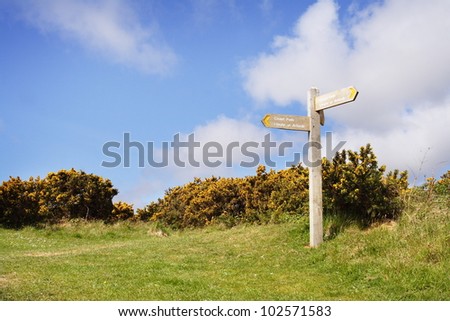Wales Coast Path signposts to areas of outstanding natural beauty - rightshifted for inclusion of text