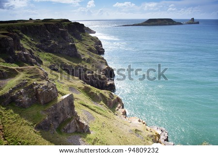Summer Sun sparkles on the sea in this view of Worms Head in Wales