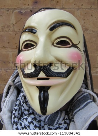 MALLORCA - MAY 15: Masked member of Anonymous in the demonstrations against the economic crisis and social injustice in the Plaza de Espana in Palma de Mallorca, Spain on May 15, 2012
