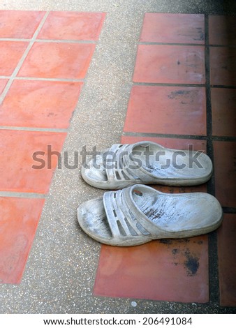 Old sandal on brick ground