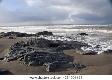 the black rocks on Ballybunion beach in county Kerry Ireland after a storm