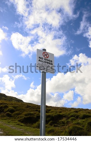 a no dogs allowed sign on a sheep farmers land
