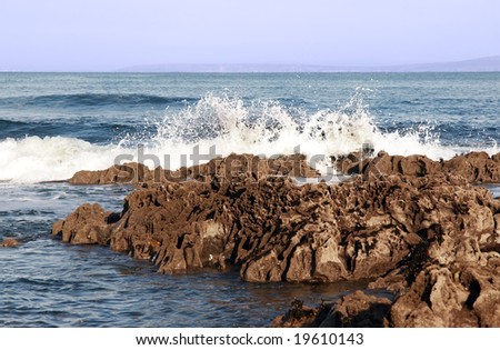 waves rolling over rocks on an irish beach