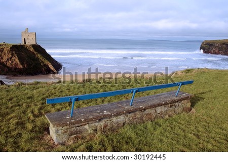 a view of snow covered ballybunion beach in winter with concrete bench