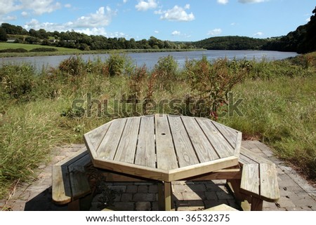 a picnic bench in knockanore county waterford in the south of ireland in summer on the blackwater river edge