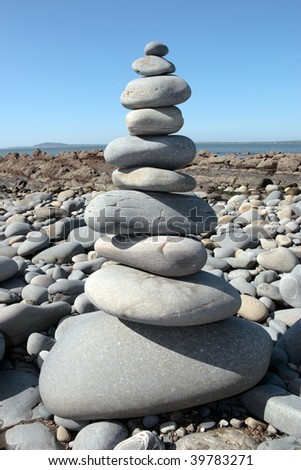 rocks balanced on a calm spiritual beach on the coast of ireland