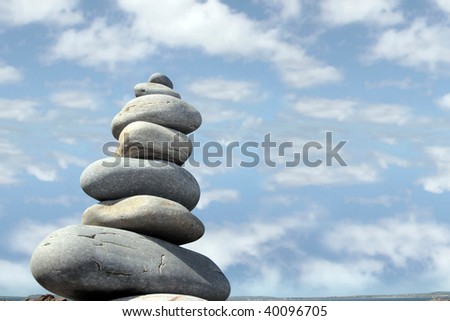 rocks balanced on a calm spiritual beach on the coast of ireland with cloudy sky
