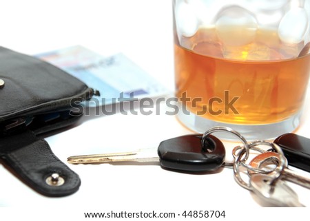 whiskey glass with car keys and cash on white background depicting gambling with drunk driving and addictions can kill