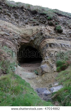 the entrance to a cave on the coast of ireland in ballybunion county kerry
