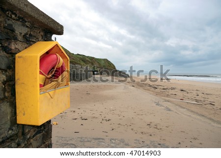 a rescue buoy at ballybunion beach in ireland on a cold deserted winters day